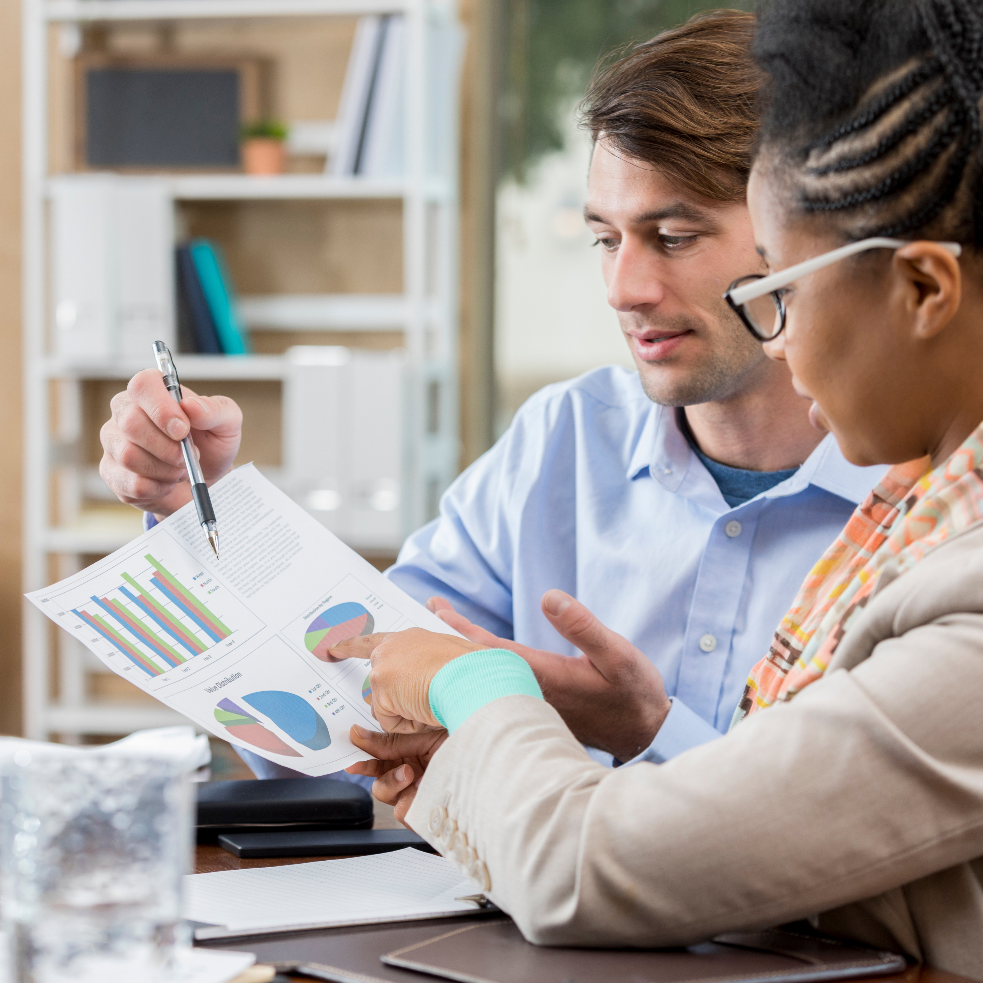 An image of business owners discussing a clean, easy-to-read financial statement or report.